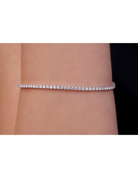 White gold tennis bracelet with diamonds .